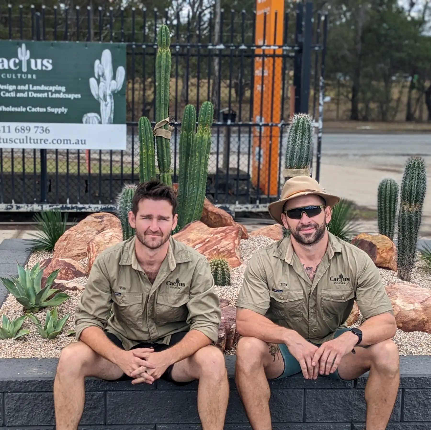 tim and billy, the owners of cactus culture sitting in front of a display garden at rock n soil landscaping yard